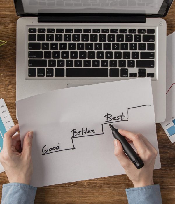 top-view-office-desk-with-growth-chart-held-by-hands